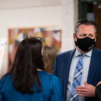 Administrators wearing masks talking about the event.